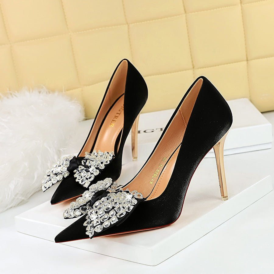 0811e9b69c4e618e87b1624c39f3b743 BIGTREE 1829-H9 European and American Style Banquet Women's Shoes Metal Heel Super High Heel Satin Shallow Mouth Pointed Toe Rhinestone Bow Pumps - Image 1